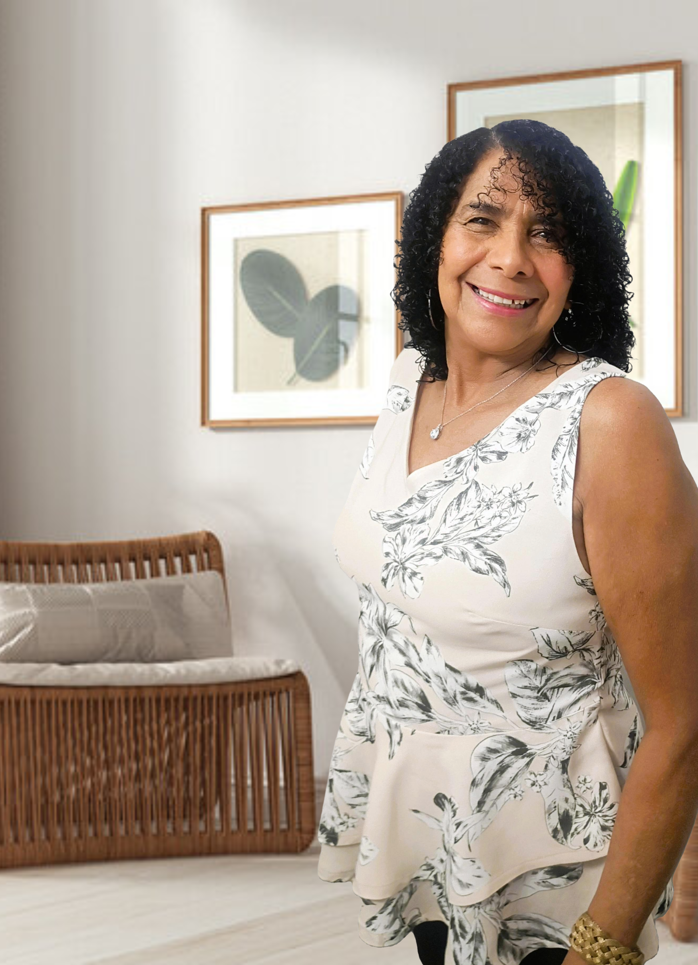 Woman standing in a room with a crib and framed pictures on the wall