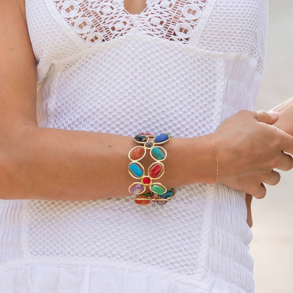 Colorful bracelet on a person wearing a white lace top