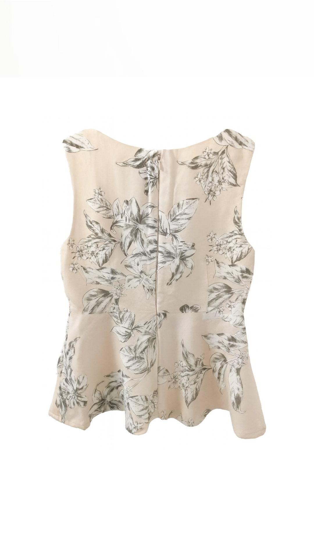 Back view of the beige floral linen blend peplum blouse showing the zipper closure and layered flare hem